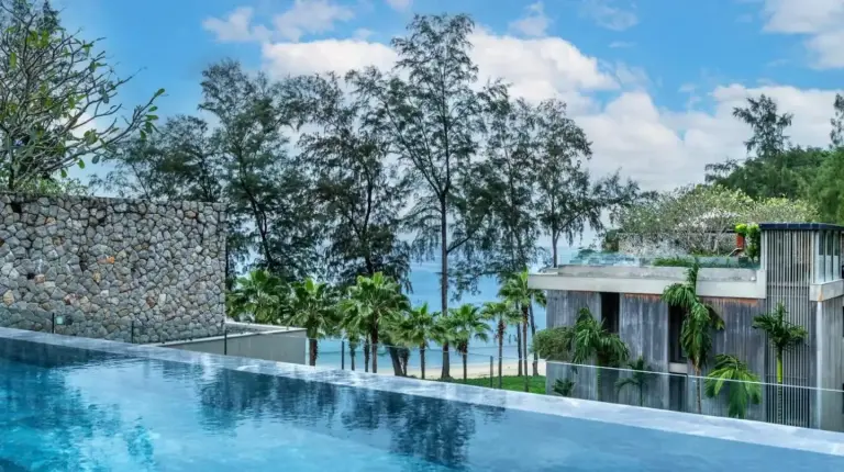 a swimming pool with a view of the ocean at Luxury Penthouse 407sqm Beachfront and private pool in Phuket Town
