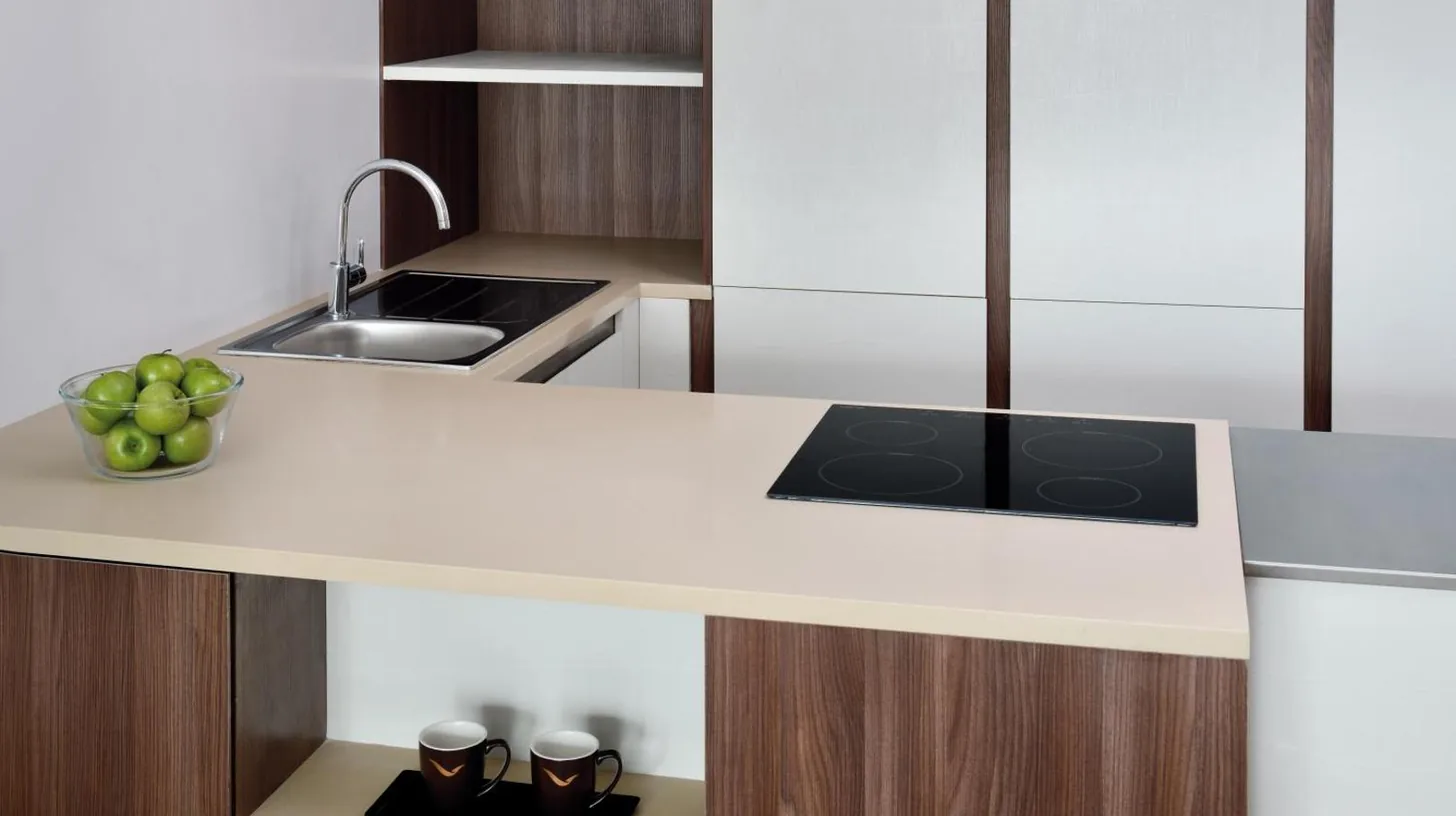 a kitchen with a white counter with a bowl of apples at Mövenpick Hotel Apartments Downtown Dubai in Dubai