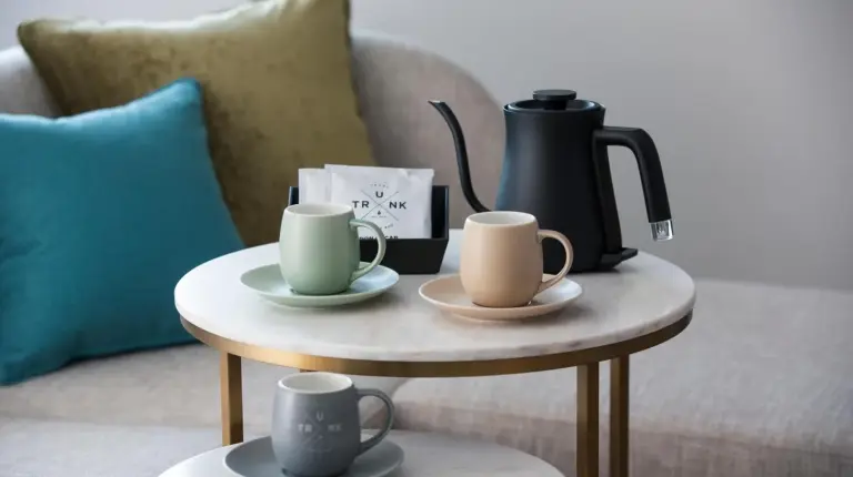 a coffee table with two cups and a coffee maker on it at Nikko Style Nagoya in Nagoya