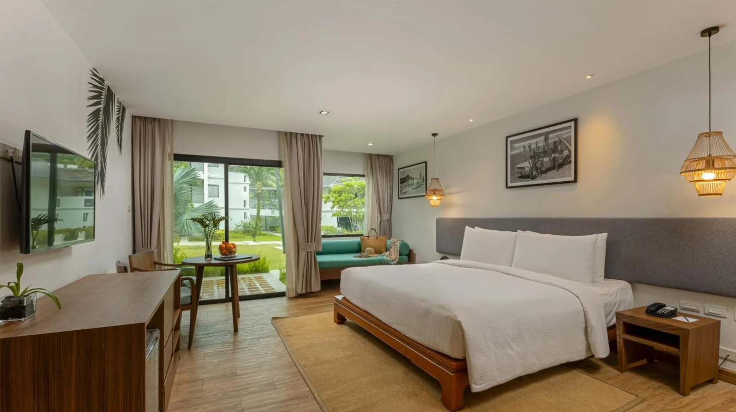 a large patio with a table and chairs at OUTRIGGER Khao Lak Beach Resort in Khao Lak