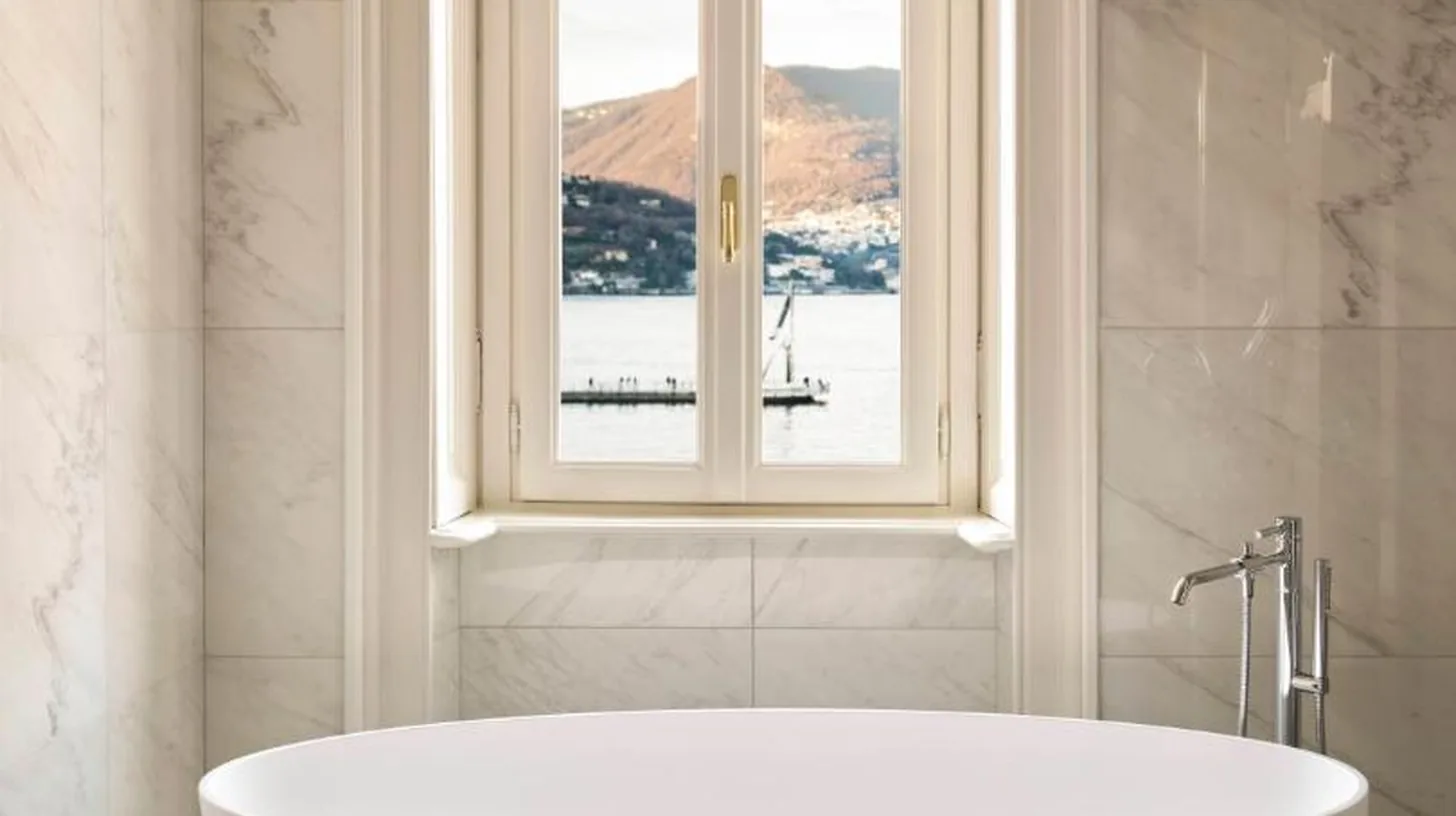 a white bath tub in a bathroom with a window at Palazzo Venezia in Como