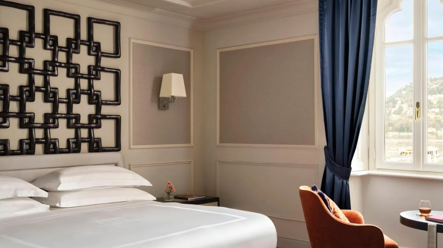 a bedroom with a large white bed and a window at Palazzo Venezia in Como