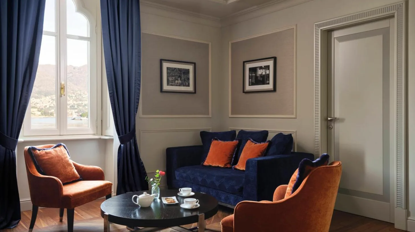 a living room with a blue couch and a table at Palazzo Venezia in Como