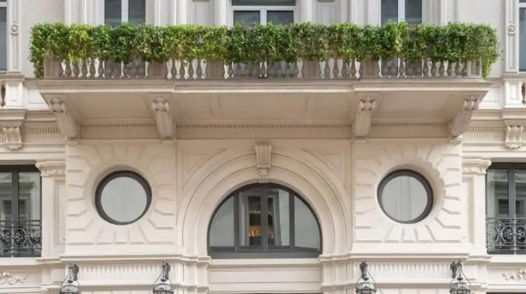 a large white building with a balcony at Park Hyatt Milano in Milan