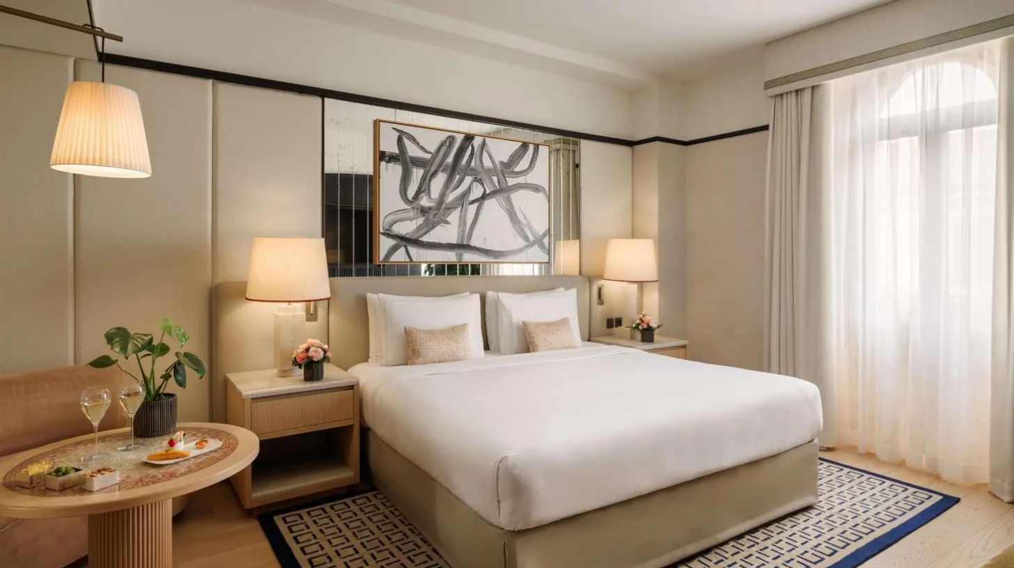 a bedroom with a large bed and a table at Park Hyatt Milano in Milan