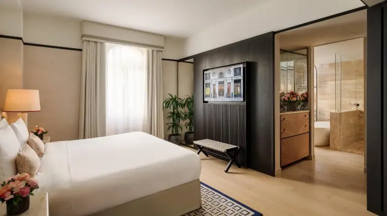 a bedroom with a large white bed and a bathroom at Park Hyatt Milano in Milan