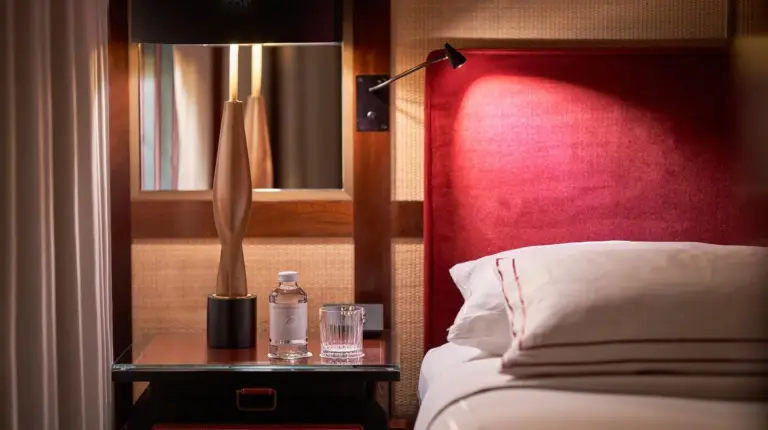 a hotel room with a large bed and a desk and a desk at Portrait Milano - Lungarno Collection in Milan