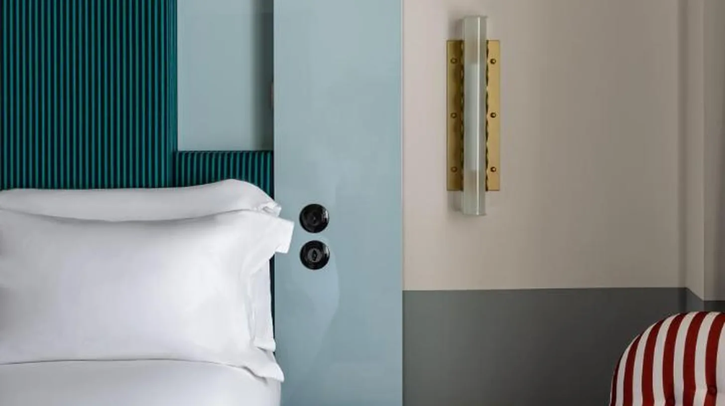 a hotel room with a bed and a table with a bed sidx sidx at Regina Experimental Biarritz in Biarritz