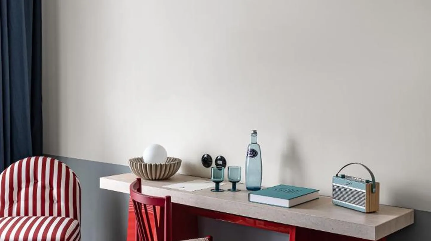 a bedroom with a desk and a bed and chairs at Regina Experimental Biarritz in Biarritz