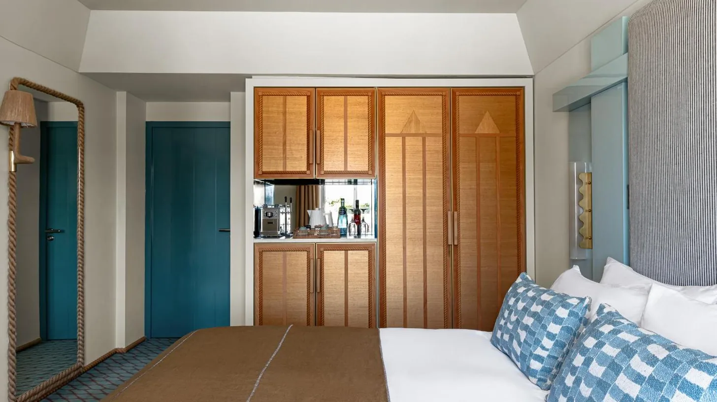 a bedroom with a bed and a kitchen at Regina Experimental Biarritz in Biarritz