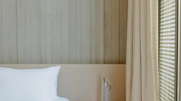 a bedroom with a white bed and a window at Sezz Saint-Tropez in Saint-Tropez