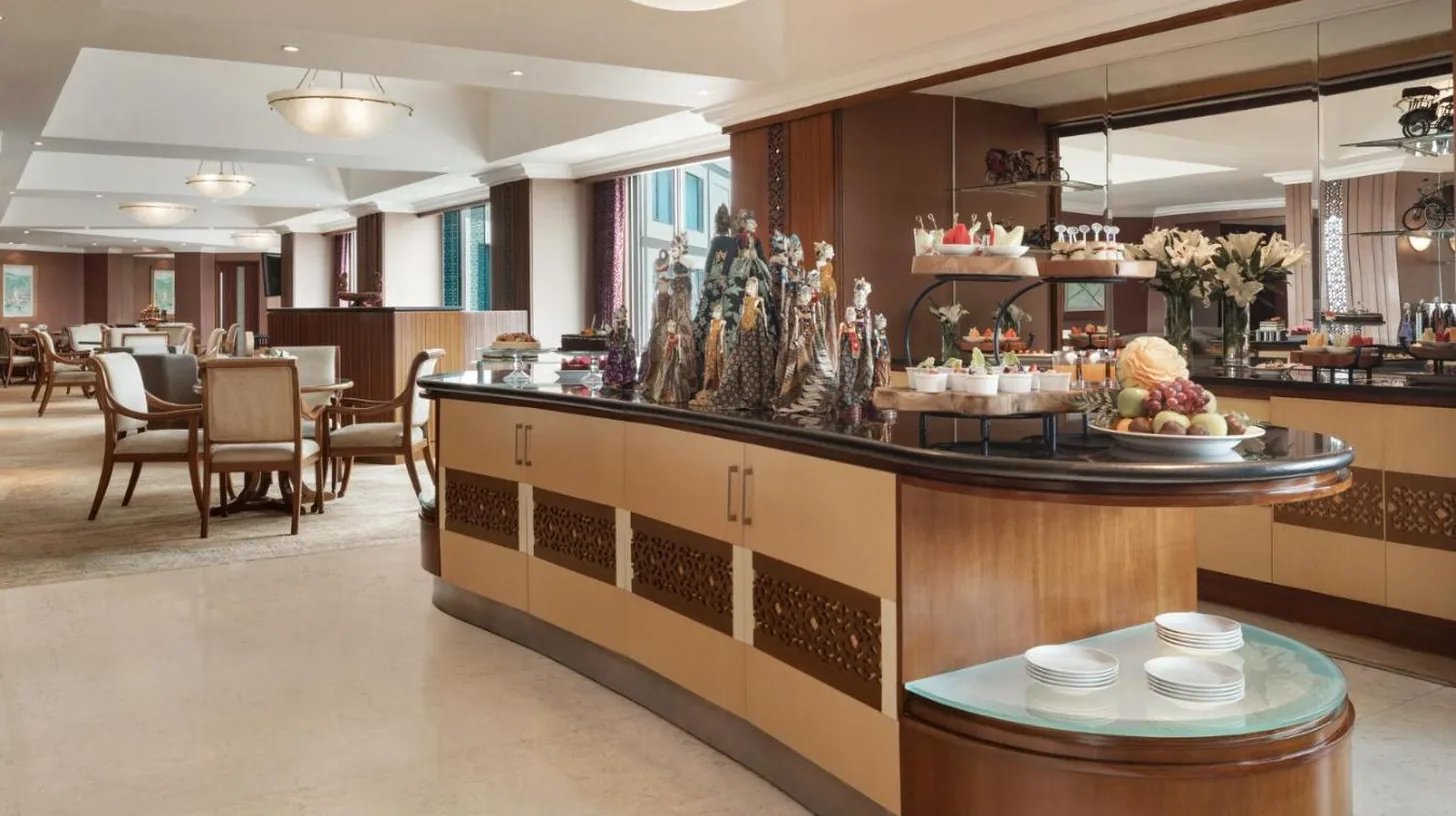 a lobby of a hotel with a breakfast bar at Shangri-la Surabaya in Surabaya