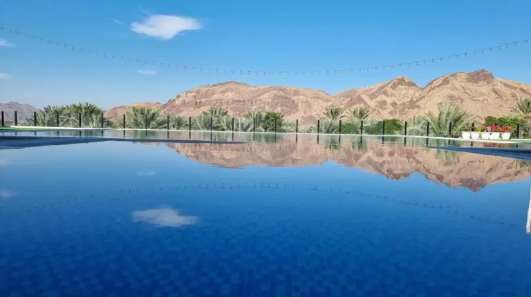 a view of the water with mountains in the background at Sheema Lodge in Hatta