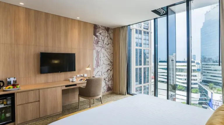 a drawer with a bottle of wine and other items at SKYVIEW Hotel Bangkok - Sukhumvit in Bangkok