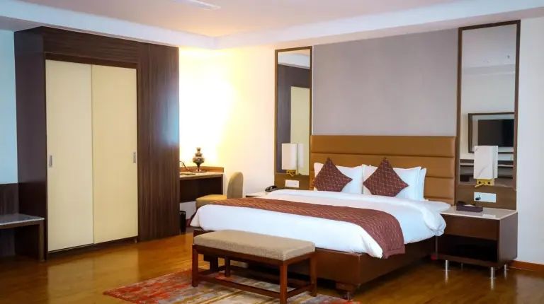 a large bedroom with a large bed and a desk at Soaltee Westend Itahari in Itahari