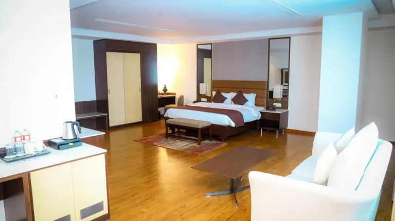a hotel room with a bed and a living room at Soaltee Westend Itahari in Itahari