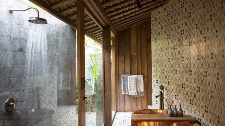 a bathroom with a wooden tub and a shower at The Asa Maia - Bespoke Wellness Resort in Uluwatu
