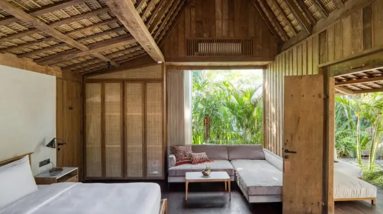 a living room with a couch and a bed at The Asa Maia - Bespoke Wellness Resort in Uluwatu