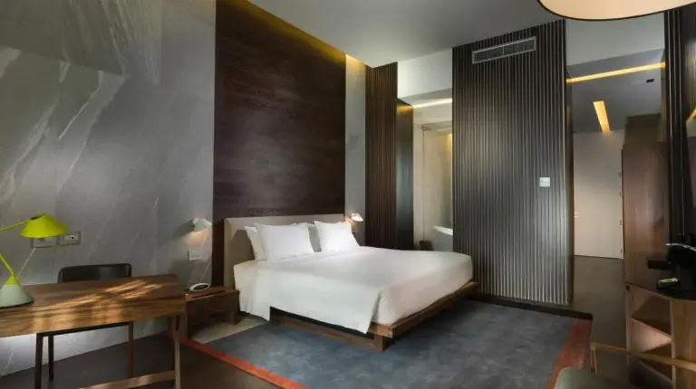 a white bath tub in a bathroom with a shower at The Glamore Milano Duomo in Milan